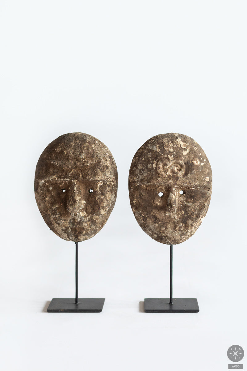Teak wood mask on a metal stand