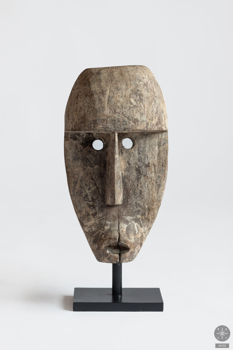 Teak wood mask on a metal stand