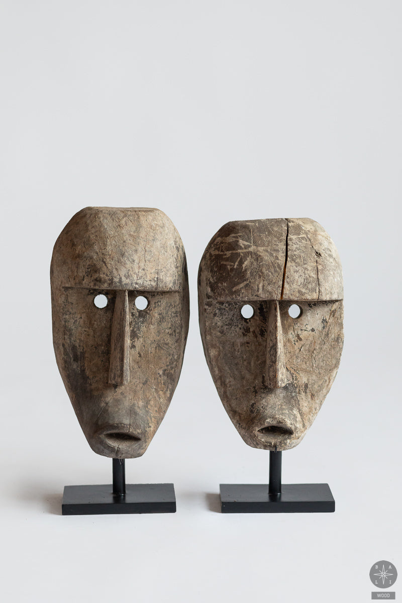 Teak wood mask on a metal stand