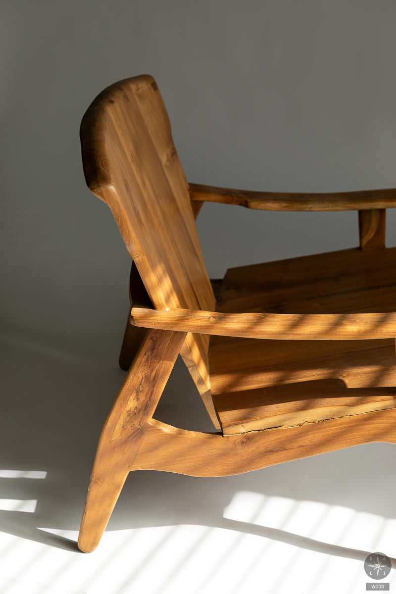 Low chair made of solid teak wood