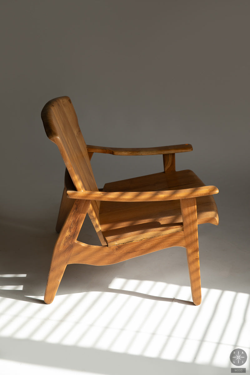 Low chair made of solid teak wood