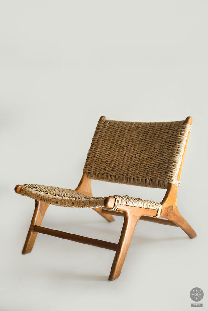 Low chair made of teak wood and synthetic rattan