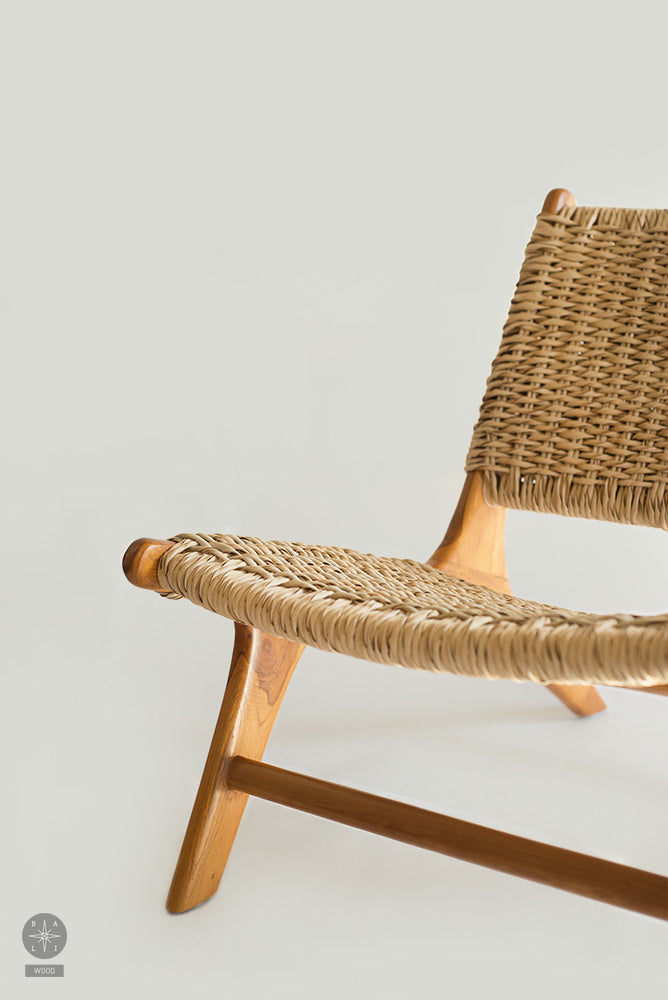 Low chair made of teak wood and synthetic rattan