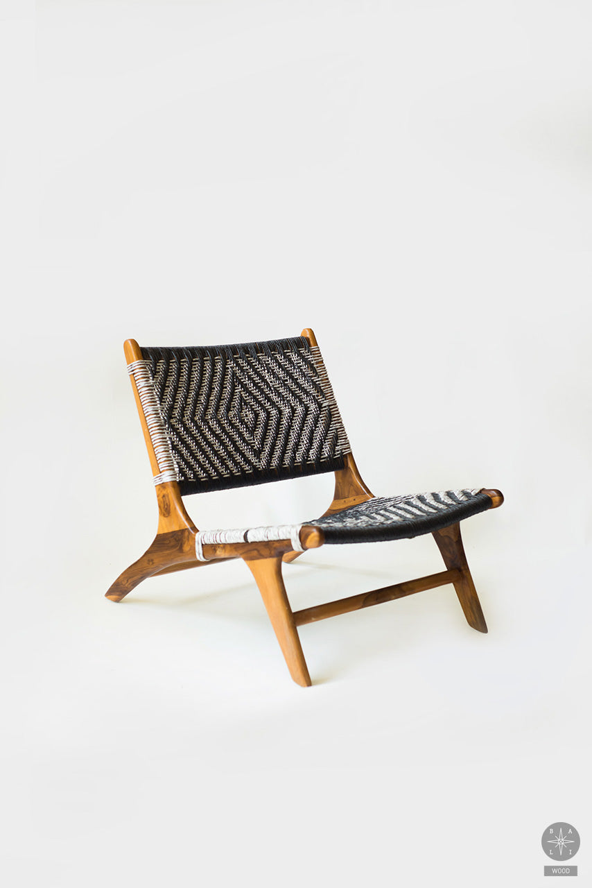 Low chair made of teak wood and synthetic rattan